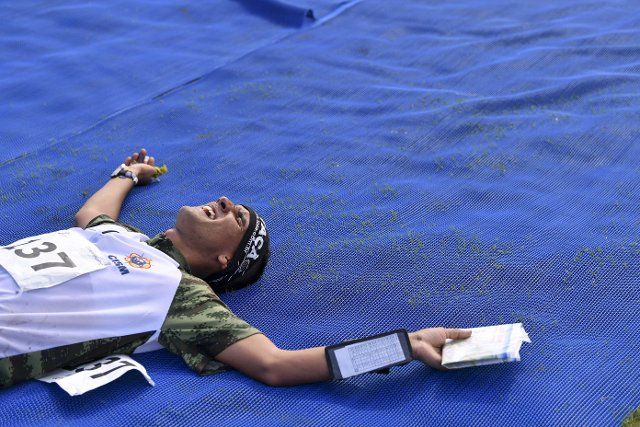 (191022) -- WUHAN, Oct. 22, 2019 (Xinhua) -- Luis Prieto of Venezuela takes a rest after finishing the men\