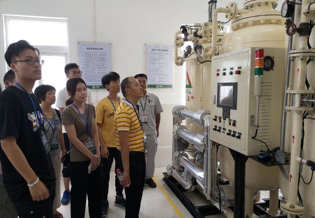 (191014) -- GUANGZHOU, Oct. 14, 2019 (Xinhua) -- People visit a machine room during an open day event at a grain depot of Sinograin in Guangzhou, capital of south China\
