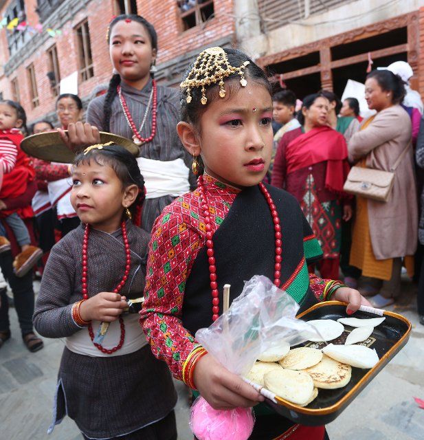 (191206) -- KIRTIPUR (NEPAL), Dec. 6, 2019 (Xinhua) -- Girls participate in the Indrayani Festival celebration at Kirtipur, outskirts of Kathmandu, Nepal, Dec. 6, 2019. The Indrayani festival is celebrated every year with the goddess Indrayani and lord Ganesh kept in chariots and roamed around the streets of Kirtipur with traditional instruments. (Photo by Sunil Sharma\/Xinhua)
