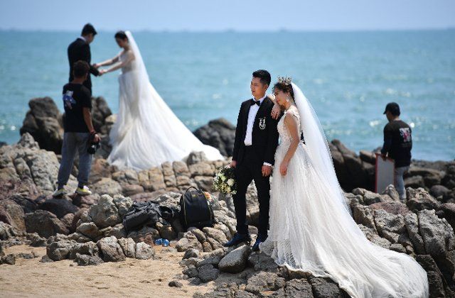 (200312) -- SANYA, March 12, 2020 (Xinhua) -- Couples pose for wedding photos at Tianyahaijiao scenic spot, or the End of the Earth, in Sanya, south China\