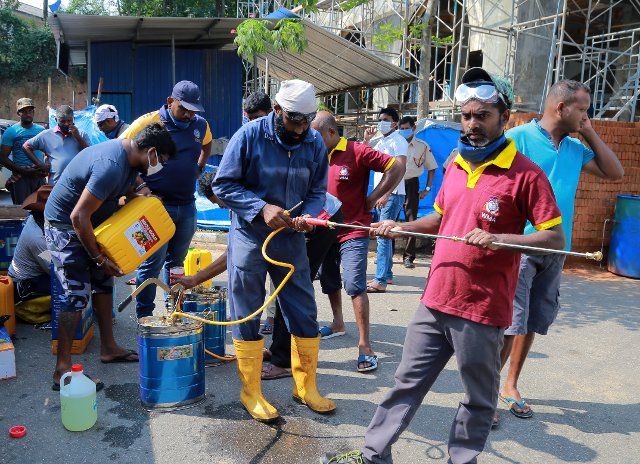 (200323) -- COLOMBO, March 23, 2020 (Xinhua) -- Workers prepare disinfectants to spray in public areas in Kotte, Sri Lanka, March 23, 2020. Ten new patients were tested positive for the COVID-19 virus in Sri Lanka on Monday, bringing the total number of infection in the country to 91, the Health Ministry said in a statement. The government earlier Monday lifted a curfew in districts other than Colombo, Puttalam, the north western province, the northern district and the outskirts of Gampaha, for a few hours to enable people to re-stock on essential items. The curfew was re-imposed again at 2:00 p.m. local time Monday. (Photo by Ajith Perera\/Xinhua)