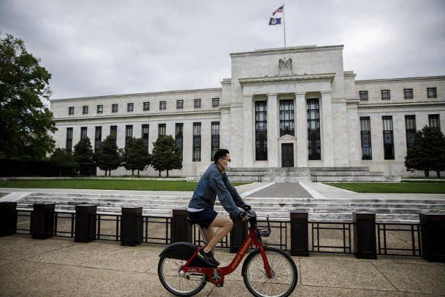 (200519) -- WASHINGTON D.C., May 19, 2020 (Xinhua) -- A cyclist wearing a mask rides by the U.S. Federal Reserve building in Washington D.C., the United States on May 18, 2020. U.S. Federal Reserve Chairman Jerome Powell said in an interview with CBS News "60 minutes" Sunday that the U.S. economy could shrink more than 30 percent in the second quarter. (Photo by Ting Shen\/Xinhua