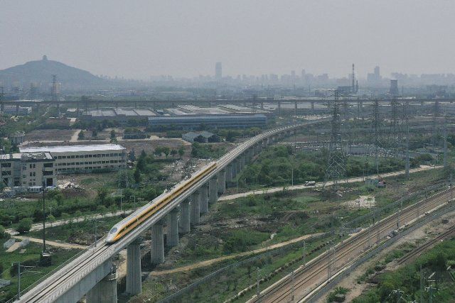 (200609) -- BEIJING, June 9, 2020 (Xinhua) -- Aerial photo taken on April 22, 2020 shows a train running during its trial operation along the Shangqiu-Hefei-Hangzhou high-speed railway in Huzhou, east China\