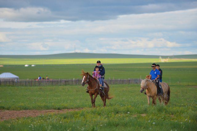 (200804) -- HULUNBUIR, Aug. 4, 2020 (Xinhua) -- Tourists ride horses at a scenic spot in Hulunbuir, north China\