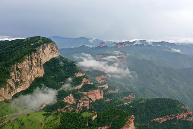 (200728) -- SHIJIAZHUANG, July 28, 2020 (Xinhua) -- Aerial photo taken on July 28, 2020 shows clouds flowing over the Taihang Mountains in Xingtai, north China\