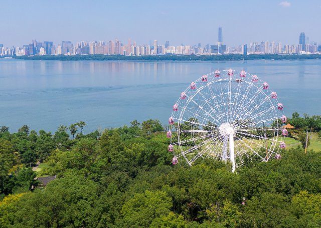 (200818) -- WUHAN, Aug. 18, 2020 (Xinhua) -- Aerial photo taken on Aug.17, 2020 shows a ferris wheel near the Donghu Lake in Wuhan, central China\