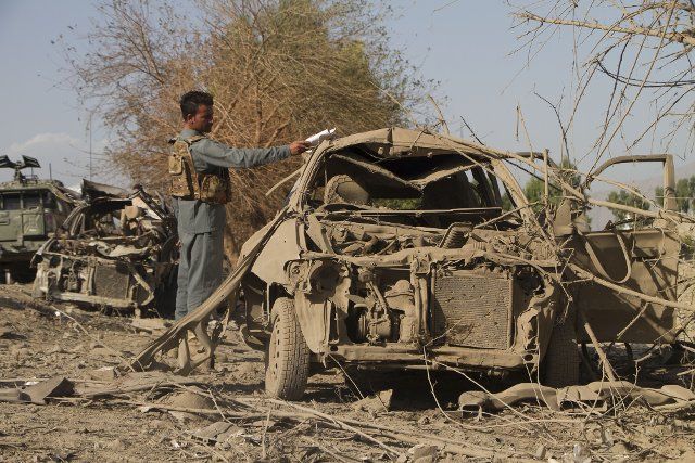 (201003) -- NANGARHAR, Oct. 3, 2020 (Xinhua) -- An Afghan security force member inspects the site of a car bomb explosion in Shinwar district of Nangarhar province, Afghanistan, Oct. 3, 2020. At least 13 people were killed and 30 others wounded in a Taliban car bomb explosion and ensuing gunfight outside a district office in Afghanistan\