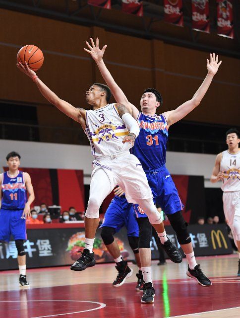 (201106) -- ZHUJI, Nov. 6, 2020 (Xinhua) -- Joseph Young (front L) of Beijing Royal Fighters goes up for a basket during the 9th round match between Beijing Royal Fighters and Xinjiang Flying Tigers at the 2020-2021 season of the Chinese Basketball Association (CBA) league in Zhuji, east China\