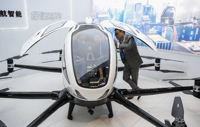 (201216) -- BEIJING, Dec. 16, 2020 (Xinhua) -- Visitors learn about an autonomous aircraft on display at an exhibition during the "China 5G + Industrial Internet Conference" in Wuhan, central China\