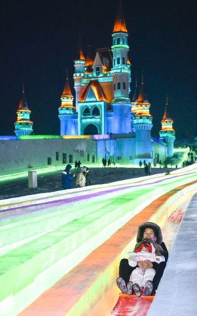 (201212) -- CHANGCHUN, Dec. 12, 2020 (Xinhua) -- Tourists enjoy an ice slide at an ice-snow theme park in Changchun, northeast China\