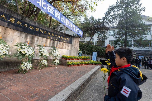 (201213) -- NANJING, Dec. 13, 2020 (Xinhua) -- Members of the Chinese Young Pioneers salute in front of a monument in commemoration of victims of the Nanjing Massacre at a mass burial place on the occasion of the seventh national memorial day in Nanjing, capital of east China\