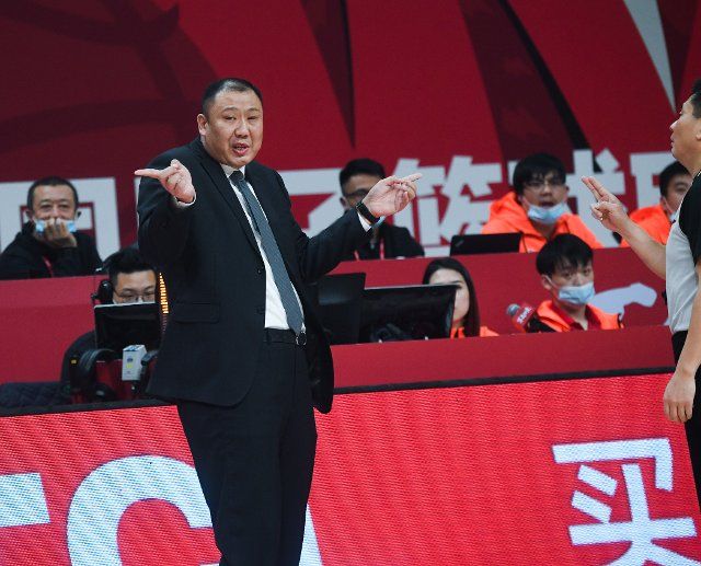 (201213) -- ZHEJIANG, Dec. 13, 2020 (Xinhua) -- Head coach of Jilin Northeast Tigers Wang Han gestures during the 18th round match between Jilin Northeast Tigers and Qingdao Eagles at the 2020-2021 season of the Chinese Basketball Association (CBA) league in Zhuji, east China\