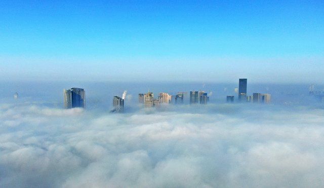 (210126) -- SHENYANG, Jan. 26, 2021 (Xinhua) -- Aerial photo shows skyscrapers shrouded in fog in Hunnan Dintrict of Shenyang, northeast China\