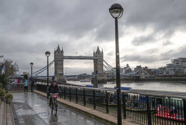 (210105) -- LONDON, Jan. 5, 2021 (Xinhua) -- A man cycles by the River Thames backdropped by the Tower Bridge in London, Britain, on Jan. 5, 2021. British Prime Minister Boris Johnson announced Monday that England will enter a national lockdown from midnight, the third of its kind since the coronavirus pandemic began in the country. (Xinhua\/Han Yan
