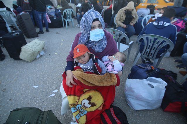 (210201) -- GAZA, Feb. 1, 2021 (Xinhua) -- A Palestinian woman wearing a face mask and her children wait at the Rafah Border Crossing in the southern Gaza Strip city of Rafah, Feb. 1, 2021. The Hamas-run Interior Ministry said on Monday that the Egyptian authorities have opened the Rafah border crossing for four days for the travel in both directions. The border opening has come for the first time in two months and it will last for four days, starting from Monday to Thursday. (Photo by Khaled Omar\/Xinhua