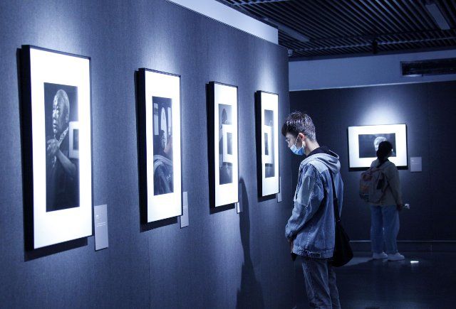 (210404) -- NANJING, April 4, 2021 (Xinhua) -- People visit a photo exhibition on Nanjing Massacre survivors at the Memorial Hall of the Victims in Nanjing Massacre by Japanese Invaders, in Nanjing, east China\