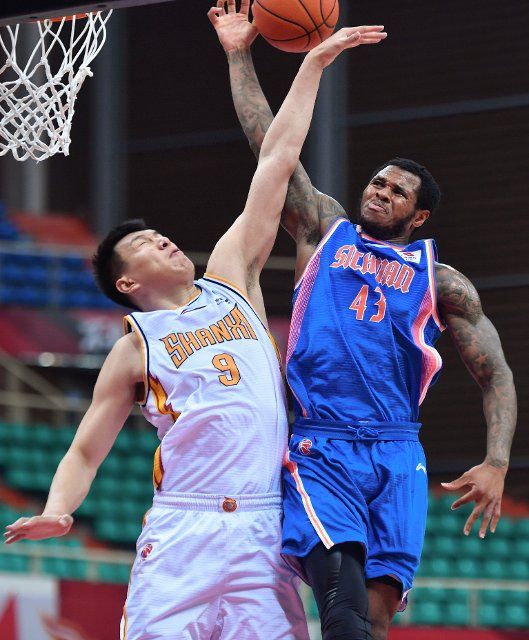 (210325) -- ZHUJI, March 25, 2021 (Xinhua) -- Ren Junwei (L) of Shanxi Loongs defends Marcus Georges-Hunt of Sichuan Blue Whales during the 48th round match between Sichuan Blue Whales and Shanxi Loongs at the 2020-2021 season of the Chinese Basketball Association (CBA) league in Zhuji, east China\