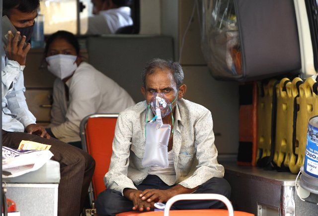 (210504) -- AHMEDABAD, May 4, 2021 (Xinhua) -- A patient gets oxygen support as a primary treatment inside an ambulance while waiting for admission inside a hospital in Ahmedabad, India, on May 3, 2021. (Str\/Xinhua