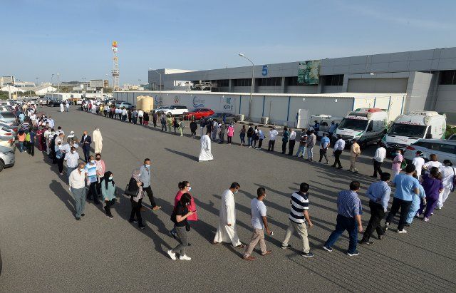 (210421) -- HAWALLI GOVERNORATE, April 21, 2021 (Xinhua) -- People queue up to receive COVID-19 vaccine outside the Kuwait Vaccination Center in Hawalli Governorate, Kuwait, April 20, 2021. Kuwait will extend the partial curfew until the end of Ramadan in efforts to curb the spread of COVID-19, the Kuwaiti government announced Monday. (Photo by Asad\/Xinhua