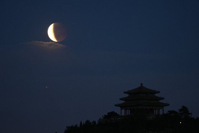 (210526) -- BEIJING, May 26, 2021 (Xinhua) -- Lunar eclipse is seen above Beijing, capital of China, May 26, 2021. (Xinhua\/Ju Huanzong