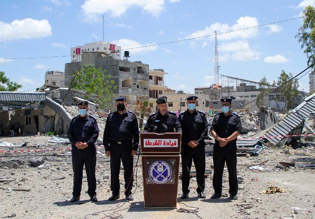 (210522) -- GAZA, May 22, 2021 (Xinhua) -- Palestinian policemen of Hamas government are seen in front of the damaged governmental building attacked by Israeli airstrikes in Gaza city, on May 22, 2021. (Photo by Rizek Abdeljawad\/Xinhua