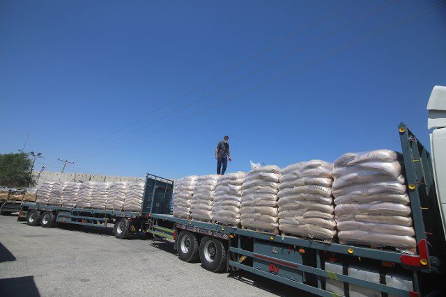 (210526) -- RAFAH, May 26, 2021 (Xinhua) -- A Palestinian worker inspects goods on a truck after it passed the Kerem Shalom Crossing in the southern Gaza Strip city of Rafah, on May 25, 2021. The Kerem Shalom crossing is open for humanitarian cargo. All crossings to Gaza should be opened and remain as such for the entrance of essential and humanitarian supplies, including fuel for basic services and supplies to curb the spread of COVID-19, said the UN Office for the Coordination of Humanitarian Affairs (OCHA) on Tuesday. (Photo by Khaled Omar\/Xinhua
