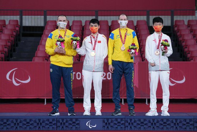 (210830) -- TOKYO, Aug. 30, 2021 (Xinhua) -- Gold medalist Zhao Shuai (2nd L) of China, silver medalist Viktor Didukh (1st L) of Ukraine, bronze medalist Maksym Nikolenko (2nd R) of Ukraine and Peng Weinan pose on the podium during the awarding ceremony for the men\
