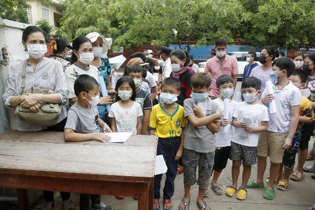 (210921) -- PHNOM PENH, Sept. 21, 2021 (Xinhua) -- Children wait for the first dose of COVID-19 vaccine at an inoculation center in Phnom Penh, Cambodia on Sept. 20, 2021. TO GO WITH "Roundup: Cambodia inoculates 75 pct population against COVID-19" (Photo by Phearum\/Xinhua