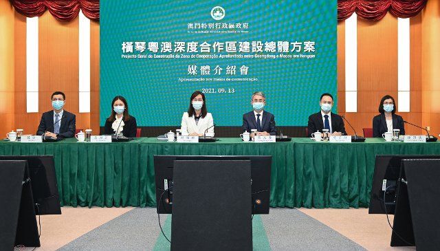 (210914) -- MACAO, Sept. 14, 2021 (Xinhua) -- Cheong Weng Chon (3rd R), secretary for administration and justice of the Macao Special Administrative Region (SAR) government, and Ao Ieong U (4th R), secretary for social affairs and culture, attend a press conference in Macao, south China, on Sept. 13, 2021. Institutional innovation and rule of law are vital to the steady and sustained development of the Guangdong-Macao in-depth cooperation zone in Hengqin, the Macao SAR government said Monday. The central authorities earlier this month made public a general plan of building the Guangdong-Macao in-depth cooperation zone in Hengqin, which is located in the southern part of Zhuhai city in Guangdong Province, just across Macao, to facilitate Macao\