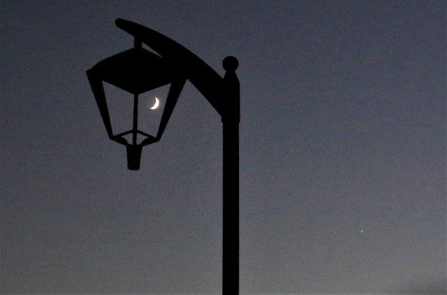 (211010) -- BEIRUT, Oct. 10, 2021 (Xinhua) -- The moon and Venus are seen in the sky over Beirut, Lebanon, on Oct. 10, 2021. (Xinhua\/Liu Zongya