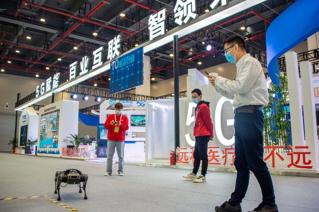 (211120) -- WUHAN, Nov. 20, 2021 (Xinhua) -- A visitor takes photos of a cyberdog at China 5G+ Industrial Internet Conference in Wuhan, central China\
