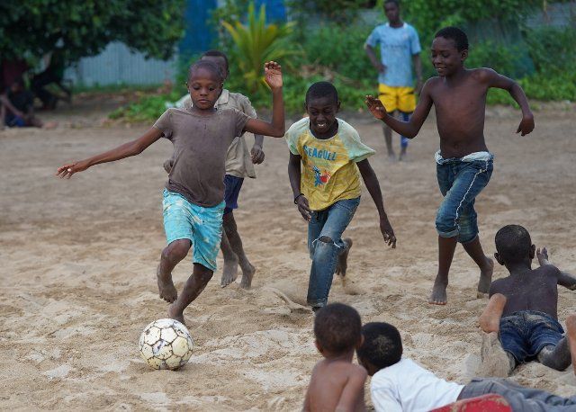 (220110) -- MOHELI, Jan. 10, 2022 (Xinhua) -- Boys play football on the beach in Moheli, Comoros, Jan. 8, 2022. (Xinhua\/Dong Jianghui