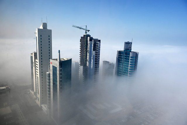 (220112) -- KUWAIT CITY, Jan. 12, 2022 (Xinhua) -- Photo taken on Jan. 12, 2022 shows buildings shrouded by fog in Kuwait City, Kuwait. (Photo by Asad\/Xinhua