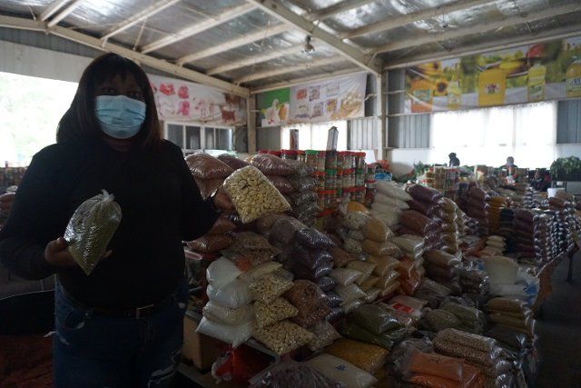 (211220) -- LUSAKA, Dec. 20, 2021 (Xinhua) -- Maria Mukela, a food trader, shows dry foods at JCS Food Market in Lusaka, Zambia, on Dec. 18, 2021. Access to decent trading spaces is a challenge for many small-scale food traders in Zambia. It is for this reason that Jihai Central Sports (JCS) Company Limited, a Chinese-owned entity operating in Zambia, decided to empower local small-scale food traders in Lusaka with clean and affordable trading spaces. (Photo by Lillian Banda\/Xinhua) TO GO WITH Feature: Chinese-run company offering Zambian small-scale food traders clean, secure trading