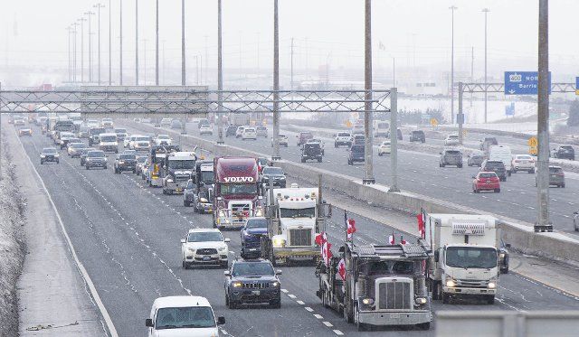 (220128) -- ONTARIO, Jan. 28, 2022 (Xinhua) -- A line of trucks are seen on Highway 400 as truckers make their way to Ottawa during the "freedom convoy" protest in Vaughan, Ontario, Canada, on Jan. 27, 2022. The "freedom convoy" was sparked by outrage over a vaccine mandate recently imposed on Canadian-U.S. cross-border truckers. (Photo by Zou Zheng\/Xinhua