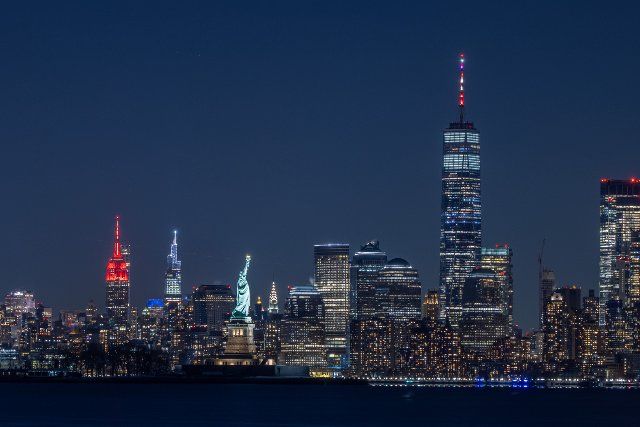 (220131) -- NEW YORK, Jan. 31, 2022 (Xinhua) -- Photo taken on Jan. 30, 2022 shows the Empire State Building and One World Trade Center lit up for the Chinese Lunar New Year, in New York, the United States. (Photo by Winston Zhou\/Xinhua
