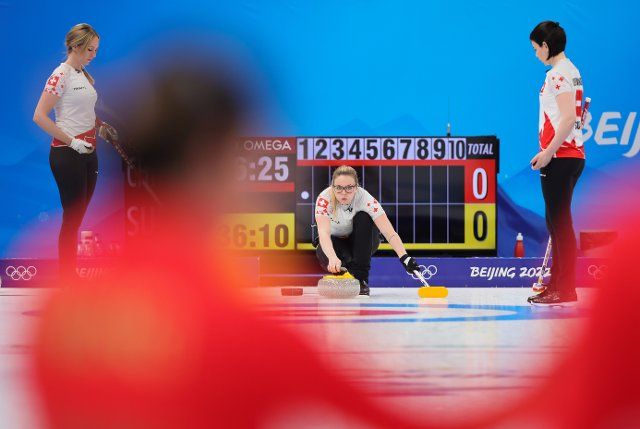 (220210) -- BEIJING, Feb. 10, 2022 (Xinhua) -- Alina Paetz (C) of Switzerland competes during the Curling Women\