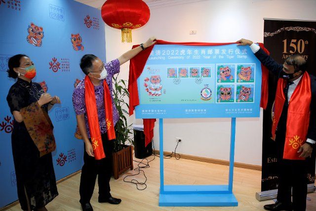 (220215) -- SUVA, Feb. 15, 2022 (Xinhua) -- Wang Xuguang (2nd L), counselor of the Chinese Embassy in Fiji, and Anirudha Bansod (R), CEO of Post Fiji, attend the launching ceremony for the Year of the Tiger stamps at the China Cultural Center in Fiji, in Suva, Fiji, on Feb. 15, 2022. The China Cultural Center in Fiji and Post Fiji jointly launched the Year of the Tiger stamps on Tuesday in celebration of the Chinese Lunar New Year. (Xinhua\/Zhang Yongxing