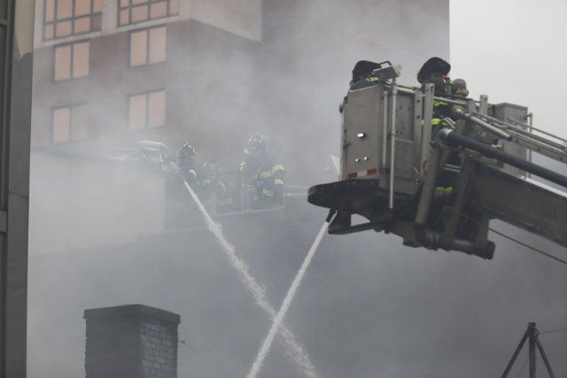 (220317) -- NEW YORK, March 17, 2022 (Xinhua) -- Fire fighters work to extinguish the fire at a commercial building in Flushing of New York, the United States, March 17, 2022. A commercial building in Flushing Chinatown of New York City suffered serious damage from a 5-alarm fire on Thursday morning. (Xinhua\/Wang Ying