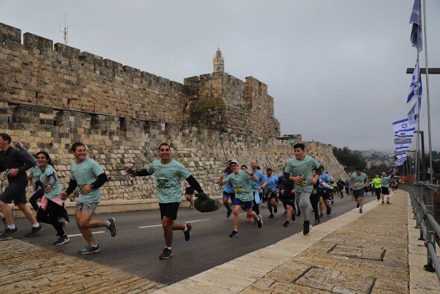 (220325) -- JERUSALEM, March 25, 2022 (Xinhua) -- Runners pass by the walls of the Old City during the 11th annual International Jerusalem Marathon in Jerusalem on March 25, 2022. (Photo by Muammar Awad\/Xinhua