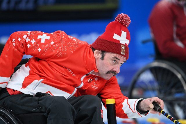 (220307) -- BEIJING, March 7, 2022 (Xinhua) -- Hans Burgener of Switzerland competes during the Wheelchair Curling Round Robin Match between Britain and Switzerland of Beijing 2022 Winter Paralympics at National Aquatics Center in Beijing, capital of China on March 7 2022. (Xinhua\/Ren Chao