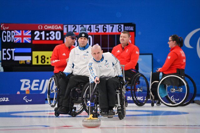 (220308) -- BEIJING, March 8, 2022 (Xinhua) -- Mait Matas (front) of Estonia competes during the Wheelchair Curling Round Robin Match between Britain and Estonia of Beijing 2022 Winter Paralympics at National Aquatics Center in Beijing, capital of China, on March 8, 2022. (Xinhua\/Wu Huiwo
