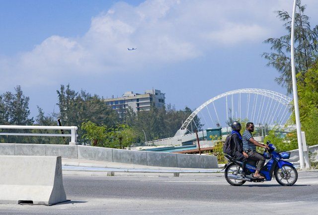 (220412) -- HULHUMALE, April 12, 2022 (Xinhua) -- People pass through a bridge built by the China State Construction Engineering Corporation (CSCEC) in Hulhumale, Maldives, Jan. 7, 2022. It all started a few years ago with the China-Maldives Friendship Bridge. Built with support from China, the opening of the bridge meant that for the first time, people could walk from capital Male to the neighboring island of Hulhumale. TO GO WITH: Feature: "New connections" -- China bridges gap in Maldives\