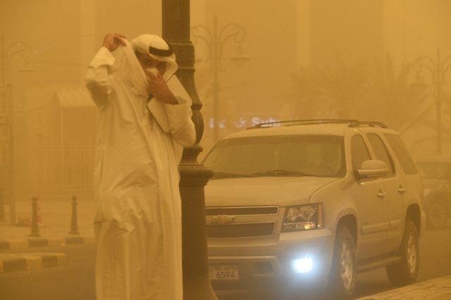 (220523) -- KUWAIT CITY, May 23, 2022 (Xinhua) -- A man walks at a street amid strong dust storm in Kuwait City, Kuwait, on May 23, 2022. (Xinhua