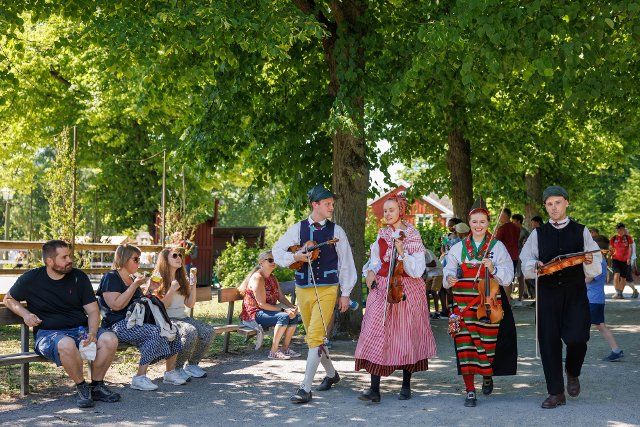 (220625) -- STOCKHOLM, June 25, 2022 (Xinhua) -- People in traditional costumes are seen in a park during the Midsummer Festival in Stockholm, Sweden, on June 25, 2022. (Photo by Wei Xuechao\/Xinhua