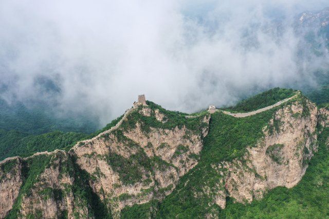 (220704) -- BEIJING, July 4, 2022 (Xinhua) -- Aerial photo taken on July 4, 2022 shows clouds floating over the Great Wall in the border area between Luanping County in north China\