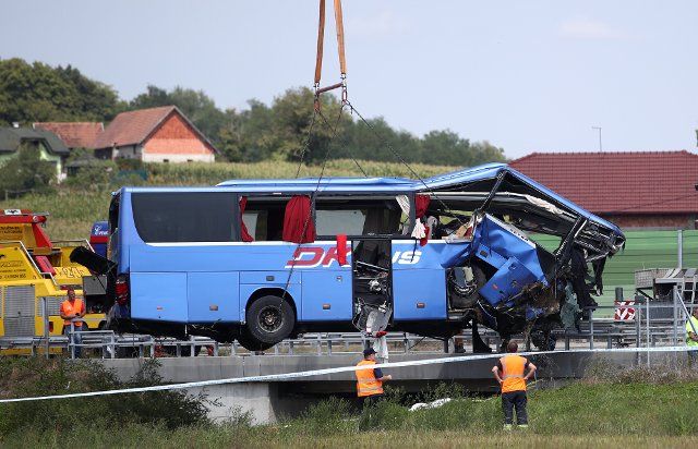 (220806) -- VARAZDIN (CROATIA), Aug. 6, 2022 (Xinhua) -- A crashed bus is removed from the site of a traffic accident near Varazdin, Croatia, on Aug. 6, 2022. Twelve people were killed and at least 30 were injured in a traffic accident when a bus with a Polish licence plate skidded off a highway in northern Croatia, according to the authorities. (Jurica Galoic\/PIXSELL via Xinhua