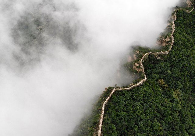 (220809) -- LUANPING, Aug. 9, 2022 (Xinhua) -- Aerial photo taken on Aug. 9, 2022 shows the Jinshanling section of the Great Wall amid clouds in Luanping County, north China\