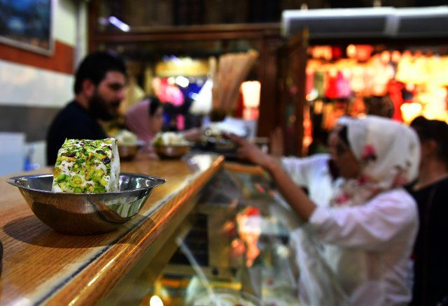(220810) -- DAMASCUS, Aug. 10, 2022 (Xinhua) -- A Syrian man serves Arabic ice cream at a shop in Damascus, Syria, Aug. 8, 2022. (Photo by Ammar Safarjalani\/Xinhua