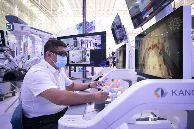 (220811) -- HARBIN, Aug. 11, 2022 (Xinhua) -- An exhibitor demonstrates the 5G remote surgery robot at the 2022 World 5G Convention in Harbin, capital of northeast China\